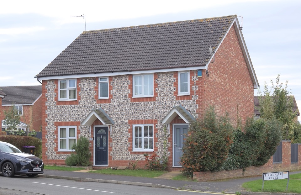 A brick and flint semi-detached house on Threlkeld Close in Gamston, Nottinghamshire